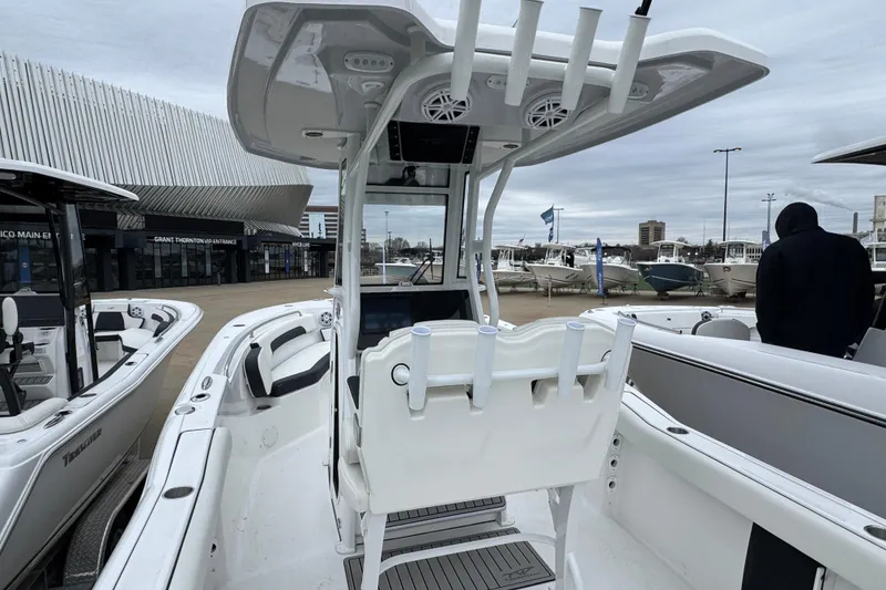 Slide: The Image of 2026 Tidewater 232 CC Adventure boat displayed at a marina with modern design features. - 4