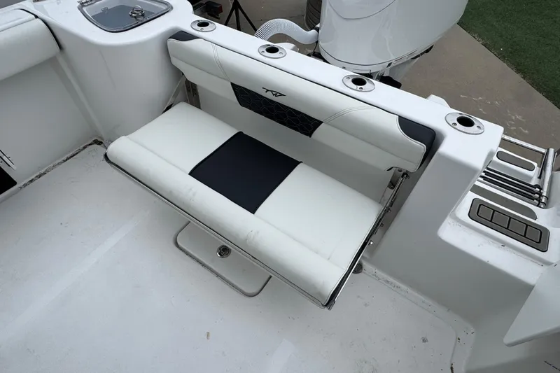 Slide: The Image of 2026 Tidewater 232 CC Adventure boat with foldable rear seat and cup holders. - 5
