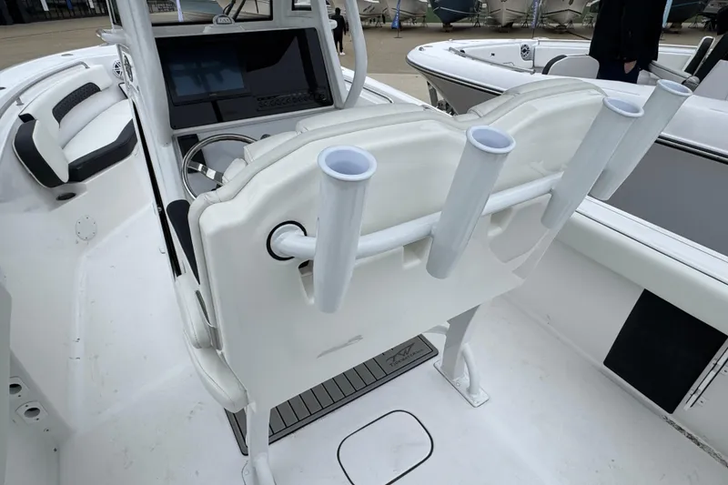 Slide: The Image of 2026 Tidewater 232 CC Adventure boat interior with rod holders and steering console. - 6