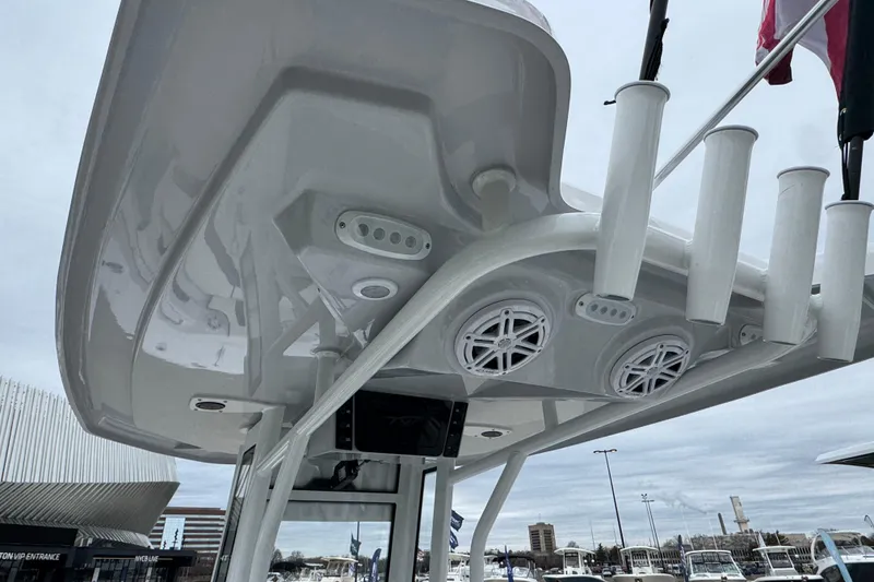 Slide: The Image of 2026 Tidewater 232 CC Adventure boat with rod holders and speakers on the T-top. - 7