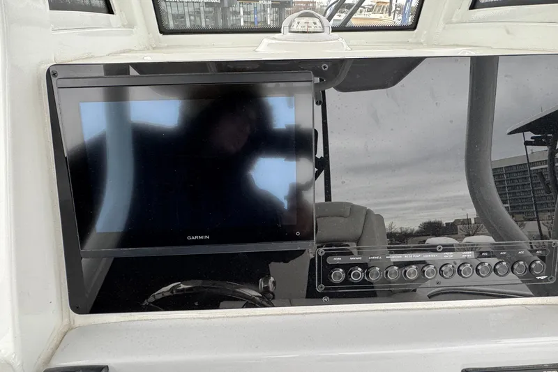 Slide: The Image of 2026 Tidewater 232 CC Adventure boat dashboard with Garmin display and control panel. - 9