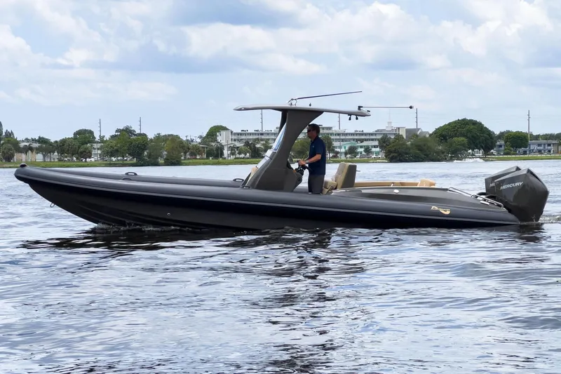 The Image of 2023 Airship 310 boat cruising on a calm lake under a cloudy sky. - 1