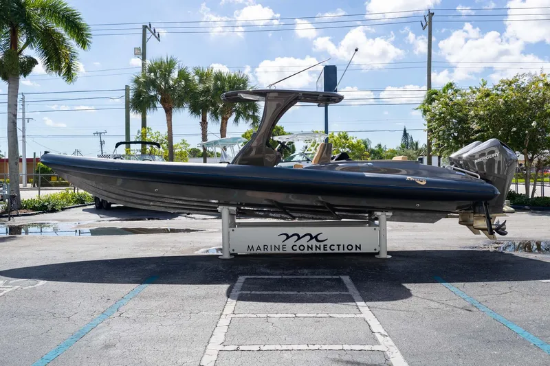 Slide: The Image of 2023 Airship 310 boat displayed outdoors at Marine Connection dealership. - 11