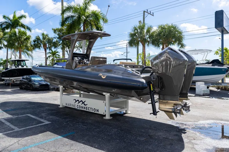 Slide: The Image of 2023 Airship 310 boat displayed at Marine Connection dealership with twin Mercury engines. - 12