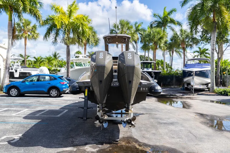 Slide: The Image of 2023 Airship 310 boat with dual engines in a sunny marina setting. - 13