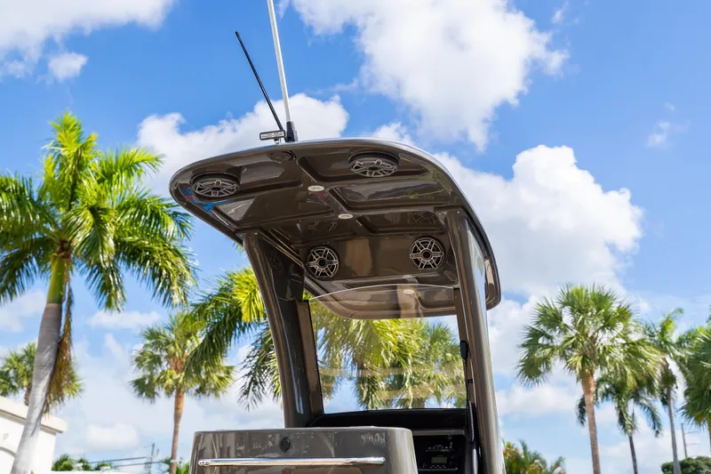 Slide: The Image of 2023 Airship 310 boat canopy with speakers, set against a tropical palm tree backdrop. - 17