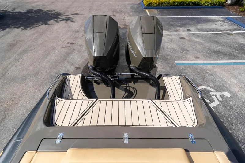 Slide: The Image of 2023 Airship 310 boat with dual Mercury outboard motors in a parking lot. - 21