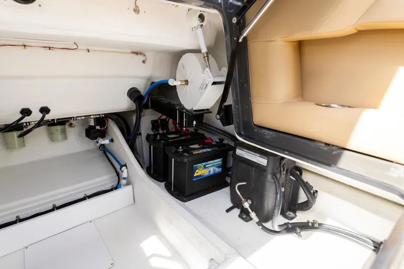 Slide: The Image of Interior view of 2023 Airship 310 boat showing battery and wiring setup. - 24