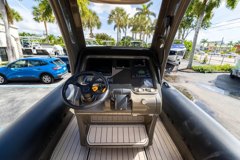 Slide: The Image of Cockpit of 2023 Airship 310 boat with steering wheel and control panel. - 29