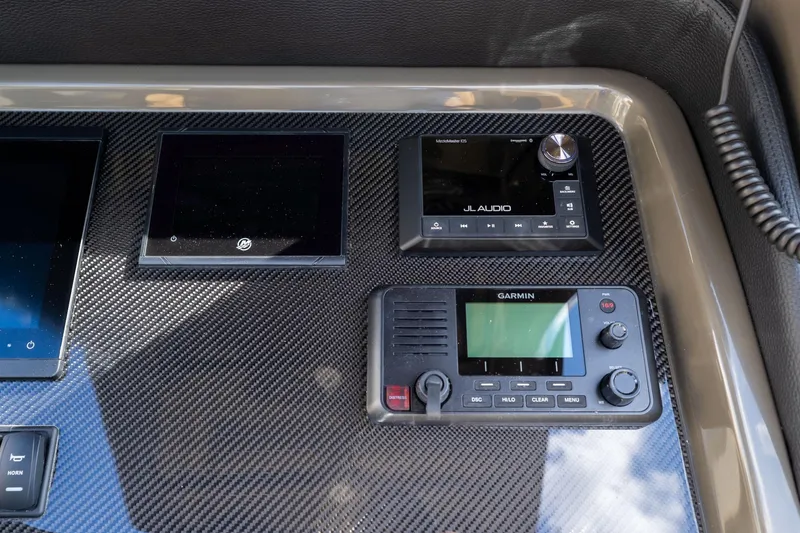 Slide: The Image of Control panel of 2023 Airship 310 featuring JL Audio and Garmin devices. - 31