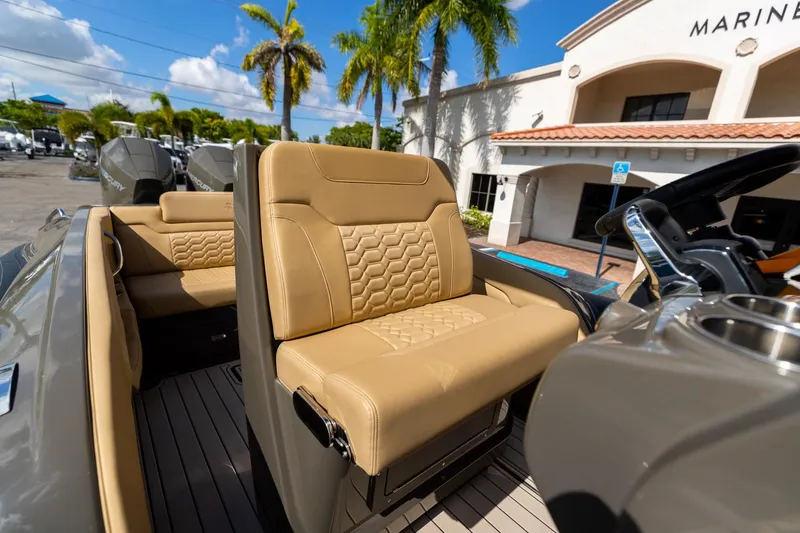 Slide: The Image of Luxurious seating on 2023 Airship 310 boat, featuring tan upholstery and modern design. - 32