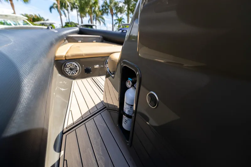 Slide: The Image of Interior of 2023 Airship 310 boat with fire extinguisher and seating area. - 36