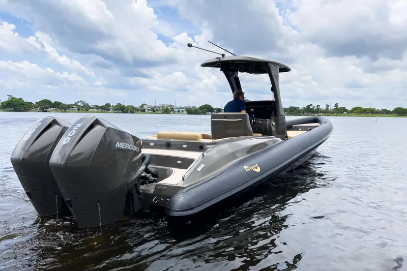 Slide: The Image of 2023 Airship 310 boat with dual Mercury engines on a calm lake. - 4
