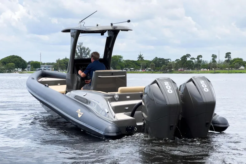 Slide: The Image of 2023 Airship 310 boat with dual Mercury engines on a calm lake. - 5