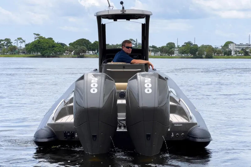 Slide: The Image of 2023 Airship 310 boat with dual Mercury 200 engines on a calm lake. - 6