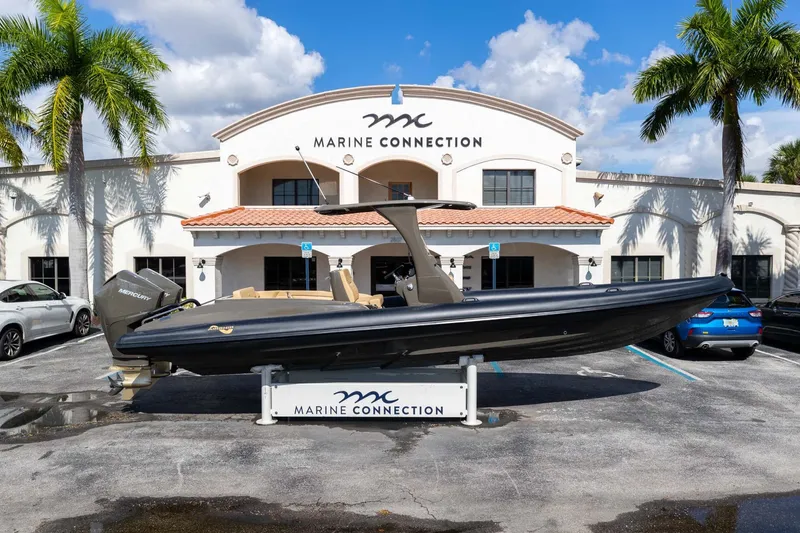 Slide: The Image of 2023 Airship 310 boat displayed at Marine Connection dealership, surrounded by palm trees. - 7