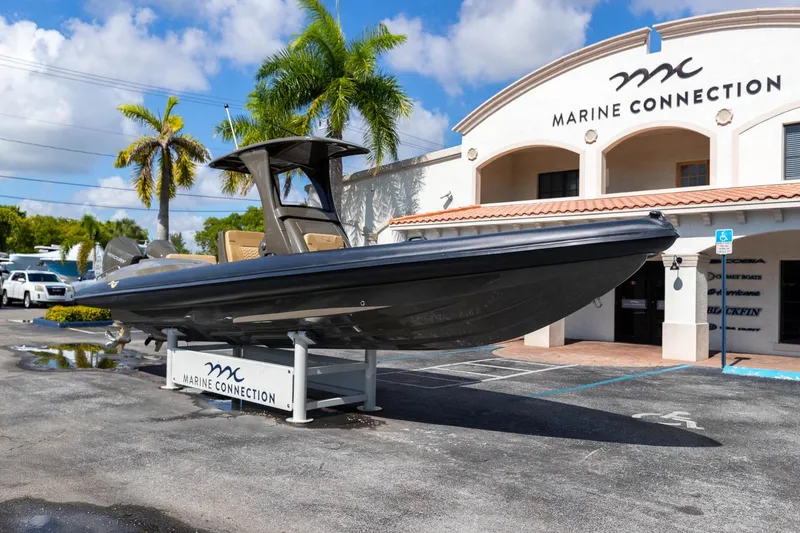 Slide: The Image of 2023 Airship 310 boat displayed at Marine Connection dealership under clear blue sky. - 8