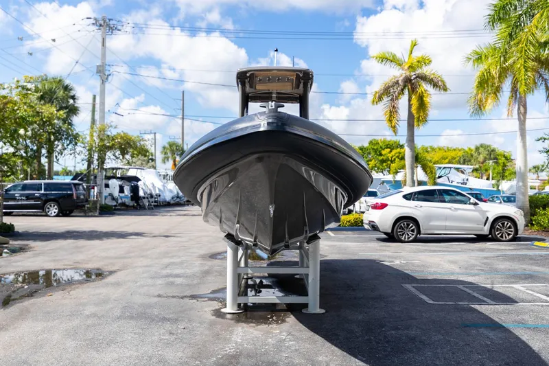 Slide: The Image of 2023 Airship 310 boat displayed in a sunny parking lot with palm trees. - 9