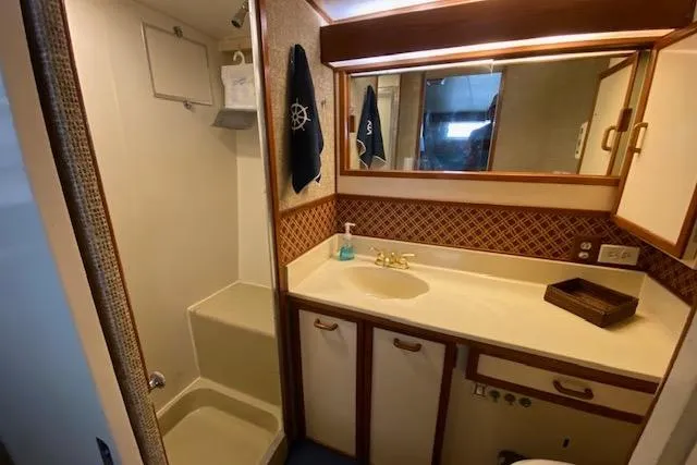 Slide: The Image of 1972 Chris-Craft boat bathroom with shower, vanity, and nautical decor. - 13