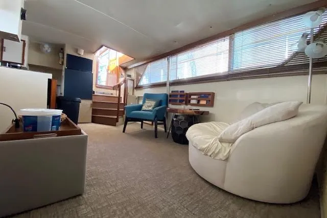 Slide: The Image of Interior of a 1972 Chris-Craft boat with cozy seating and natural light. - 18