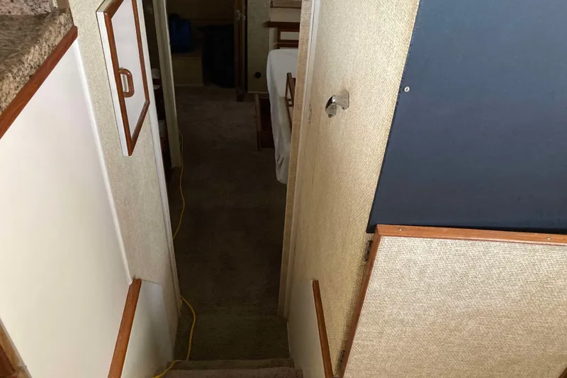 Slide: The Image of Interior view of 1972 Chris-Craft 45 Commander yacht, featuring narrow carpeted stairs. - 20