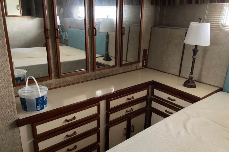 Slide: The Image of Interior of 1972 Chris-Craft 45 Commander with mirrored cabinets and a lamp. - 22