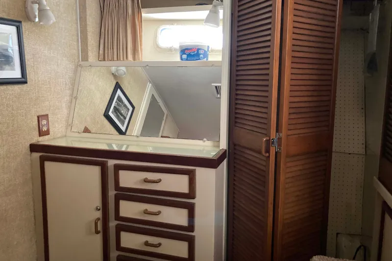 Slide: The Image of 1972 Chris-Craft 45 Commander interior with vintage cabinetry and mirror. - 25