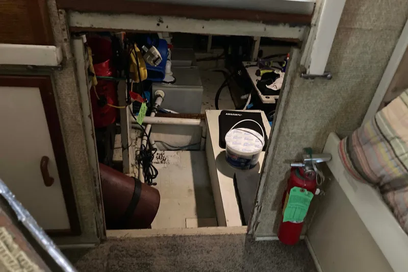 Slide: The Image of Engine room of a 1972 Chris-Craft 45 Commander with visible equipment and fire extinguisher. - 28