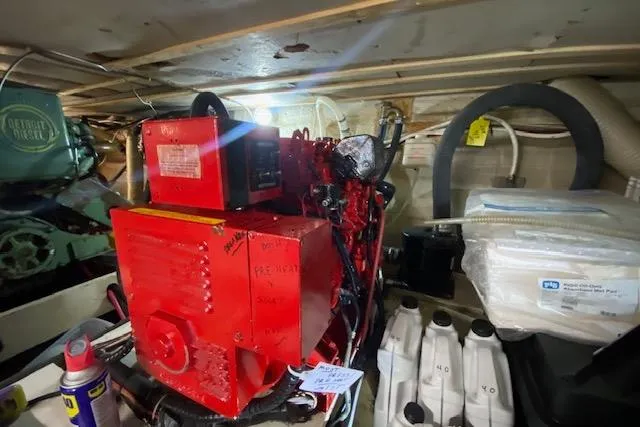 Slide: The Image of 1972 Chris-Craft engine room with red machinery and various equipment. - 30