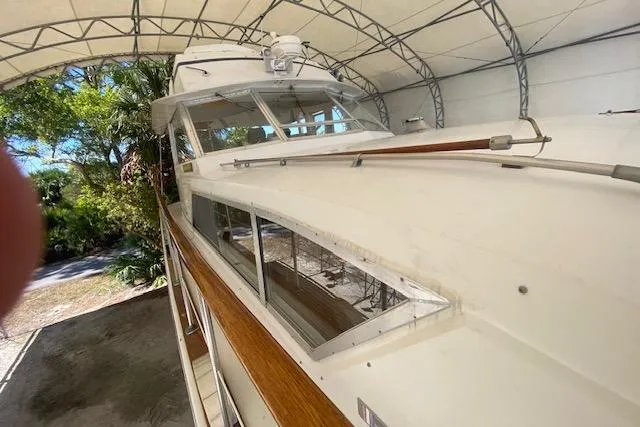 Slide: The Image of 1972 Chris-Craft boat under canopy, showcasing classic design and wooden accents. - 6