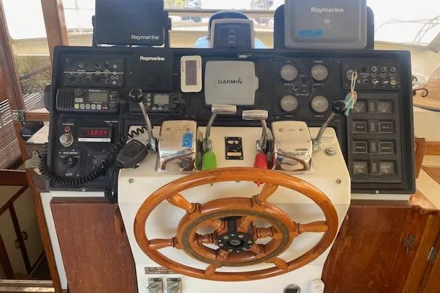 Slide: The Image of 1972 Chris-Craft boat dashboard with steering wheel, navigation instruments, and control panels. - 8