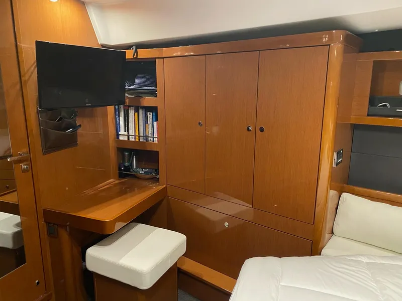 Slide: The Image of Luxurious interior of 2016 Beneteau Oceanis 60 yacht with wood cabinetry and TV. - 14