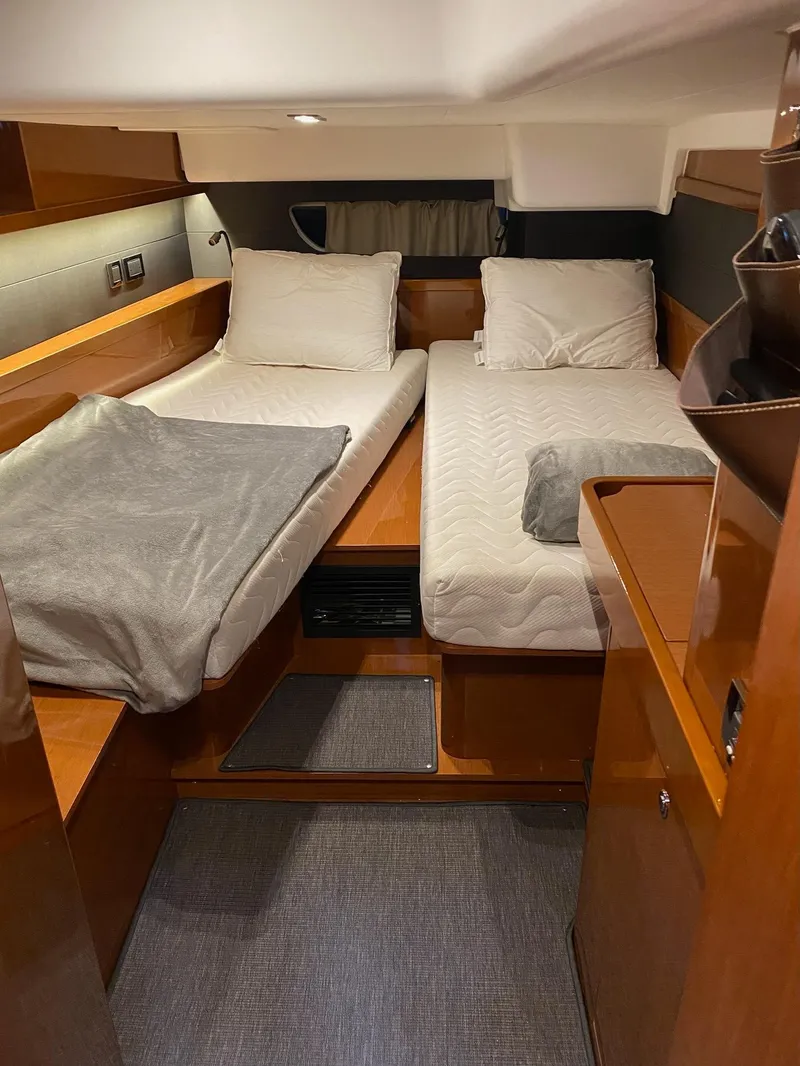 Slide: The Image of Interior cabin of 2016 Beneteau Oceanis 60 yacht with twin beds and wooden furnishings. - 17
