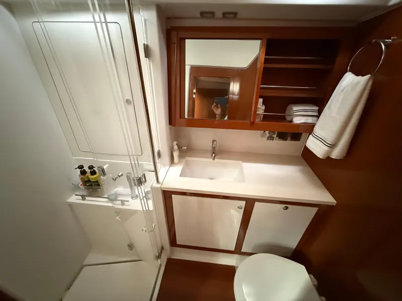 Slide: The Image of Luxurious bathroom in 2016 Beneteau Oceanis 60 yacht with modern fixtures and wooden accents. - 19