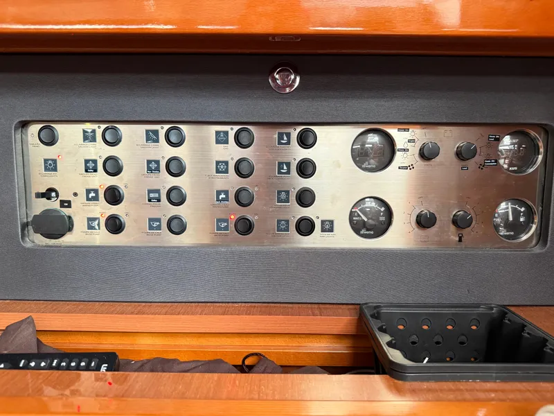 Slide: The Image of Control panel of a 2016 Beneteau Oceanis 60 yacht with various switches and gauges. - 22