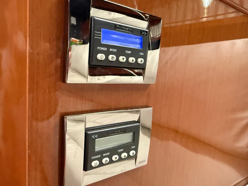 Slide: The Image of Control panels on 2016 Beneteau Oceanis 60 yacht, featuring power and temperature settings. - 24