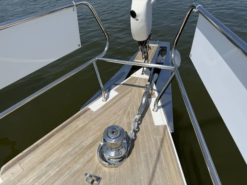 Slide: The Image of Bow of 2016 Beneteau Oceanis 60 yacht with anchor chain and winch. - 28