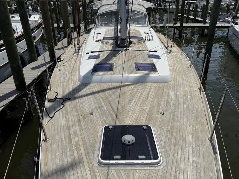Slide: The Image of 2016 Beneteau Oceanis 60 yacht with spacious teak deck, docked at marina. - 31