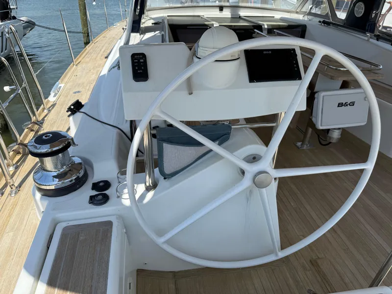 Slide: The Image of Steering wheel of 2016 Beneteau Oceanis 60 yacht, featuring modern navigation equipment. - 35