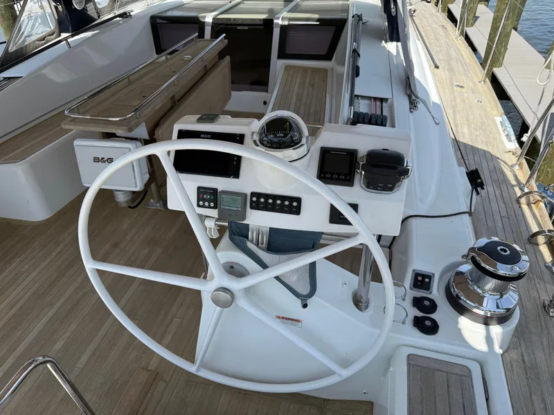 Slide: The Image of Cockpit of 2016 Beneteau Oceanis 60 sailboat with steering wheel and navigation instruments. - 36