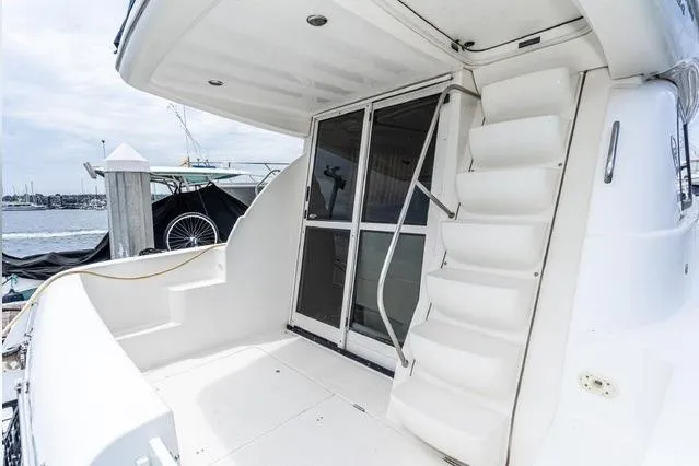 Slide: The Image of 2002 Bayliner 3488 Avanti yacht with white exterior and dockside view. - 10