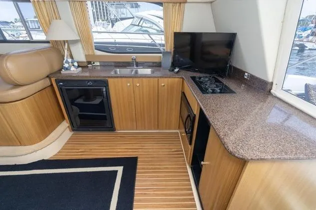 Slide: The Image of Interior of 2002 Bayliner 3488 Avanti yacht with kitchenette and modern amenities. - 11