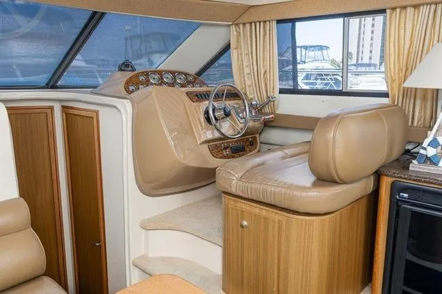 Slide: The Image of Interior helm of 2002 Bayliner 3488 Avanti with leather seating and wood accents. - 13