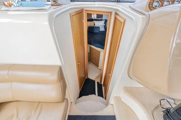Slide: The Image of Interior view of 2002 Bayliner 3488 Avanti yacht with beige seating and cabin entrance. - 16