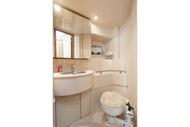 Slide: The Image of Bathroom interior of 2002 Bayliner 3488 Avanti yacht, featuring sink and toilet. - 21