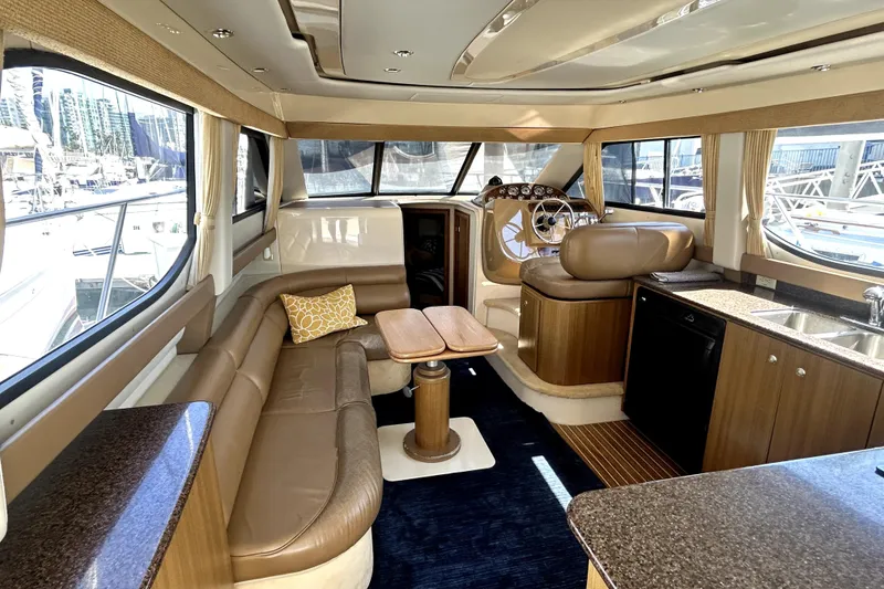 Slide: The Image of Luxurious interior of 2002 Bayliner 3488 Avanti yacht with leather seating and wooden accents. - 23