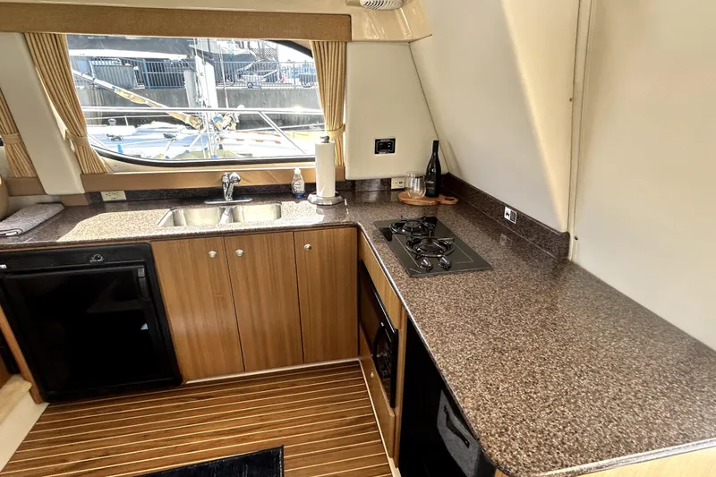 Slide: The Image of Luxurious kitchen interior of 2002 Bayliner 3488 Avanti yacht with modern amenities. - 27