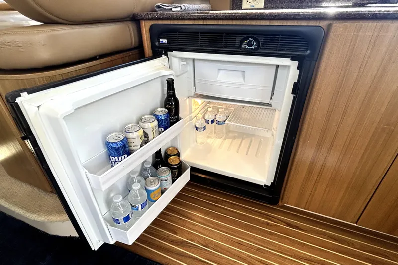 Slide: The Image of Mini fridge stocked with drinks inside a 2002 Bayliner 3488 Avanti boat cabin. - 28