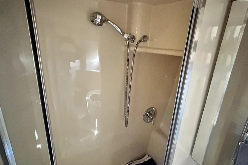 Slide: The Image of Shower area in 2002 Bayliner 3488 Avanti boat, featuring chrome fixtures and beige interior. - 29