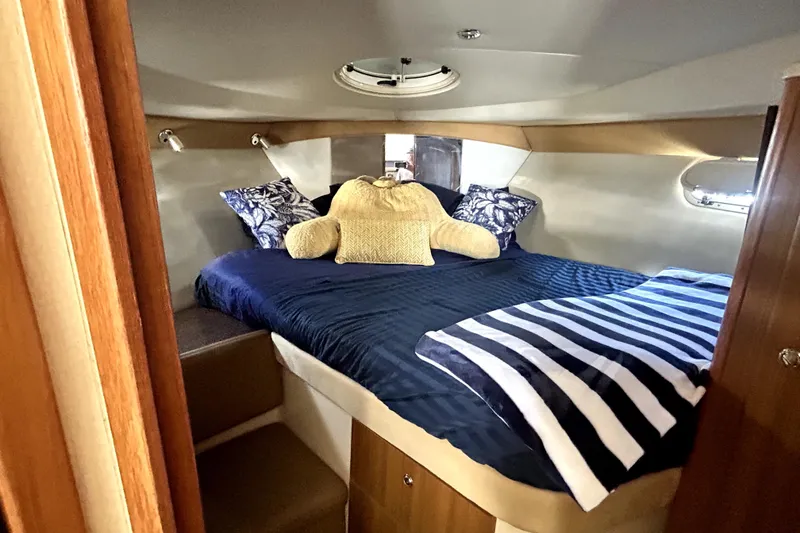 Slide: The Image of Cozy cabin interior of 2002 Bayliner 3488 Avanti with plush bedding and nautical decor. - 34